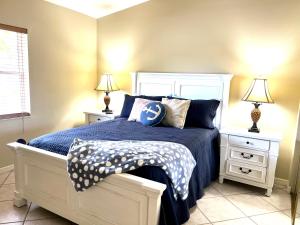 a bedroom with a bed with blue sheets and pillows at BCC Country Club in Bradenton