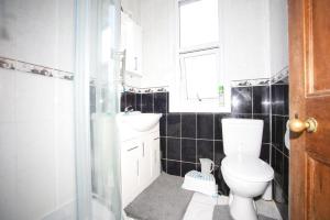 a bathroom with a toilet and a sink at 10 Valley Road, in Kent
