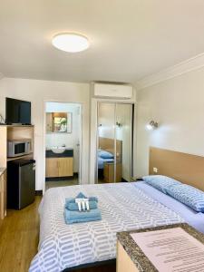 a bedroom with two beds with towels on them at Econo Lodge Karratha in Karratha