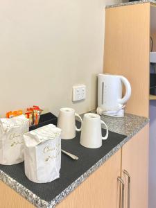 a kitchen counter with three white bags on it at Econo Lodge Karratha in Karratha