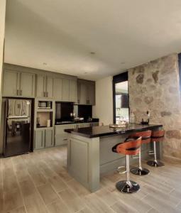 a large kitchen with a island in the middle at Casa San Sebastián - San Miguel de Allende in San Miguel de Allende