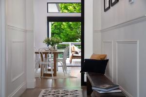 a living room with a table and chairs and a dining room at Sandringham in Daylesford