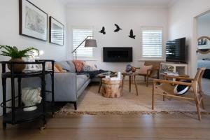a living room with a couch and a table at Sandringham in Daylesford