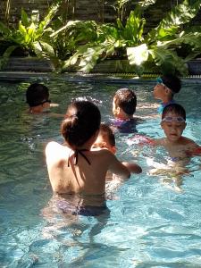 a group of children in a swimming pool at Animor Green Home Villa Da Nang in Da Nang