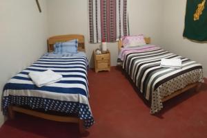 two beds sitting next to each other in a room at MUNAY TUPAY in Anansaya