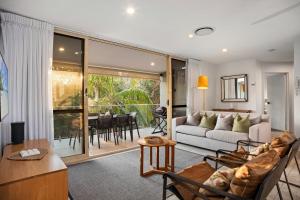 a living room with a couch and a table at #2 Hastings Street in Noosa Heads