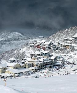 a group of buildings on a snow covered mountain at Arlberg Hotham in Mount Hotham