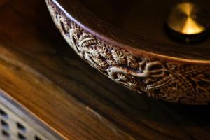 a close up of a wooden table with a candle on it at Tingjian Lingyin Alanruo Design Homestay in Hangzhou