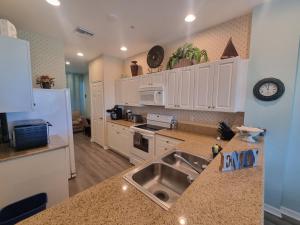 a kitchen with a sink and a counter top at Greenlinks 923 at Lely Resort - Luxury 2 Bedrooms & Den Condo in Naples