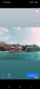 a television screen with a picture of houses on the water at Nuttonton Homes in Papas