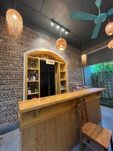 a bar with a wooden counter and a chair at Asahi Luxstay - Homestay Đường Lâm Hostel in Sơn Tây