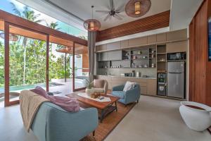 a living room with a table and chairs at The Studios Ubud-Adult Only in Ubud