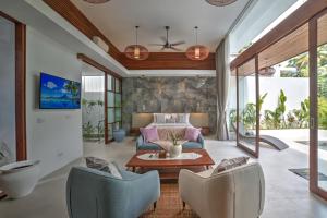 a living room with a bed and a table and chairs at The Studios Ubud in Ubud