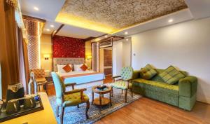 a hotel room with a bed and a couch at The Walnut Creek Pahalgam in Pahalgām