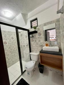 a bathroom with a toilet and a sink and a mirror at MAYAB Playa - 5Th. Ave in Playa del Carmen