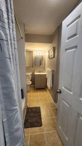 a bathroom with a toilet and a white door at Cozy King Bed, Free Parking! in Newark