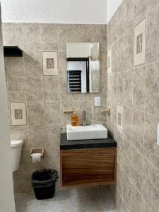 a bathroom with a sink and a mirror at MAYAB Playa - 5Th. Ave in Playa del Carmen