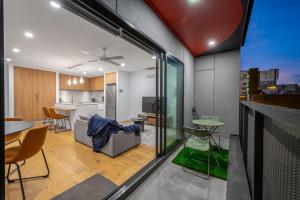 an open kitchen and dining room with a view of a house at StayCentral - Brunswick Central Townhouse in Melbourne