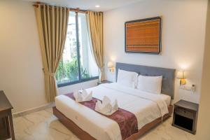 Postel nebo postele na pokoji v ubytování Marvelinn Siem Reap