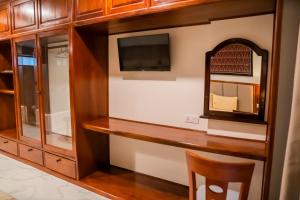 a dressing room with a mirror and a tv at Marvelinn Siem Reap in Siem Reap