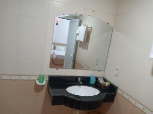 a bathroom with a black sink and a mirror at Dong Duong Hotel in Hai Phong