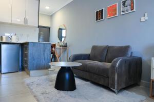 a living room with a couch and a table at Sarona City Studio L303 in Gaborone