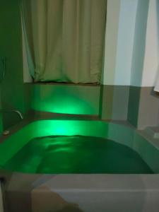 a green light in a bathroom with a shower at Torre Subrosa, vasca in camera cromoterapia in Viterbo