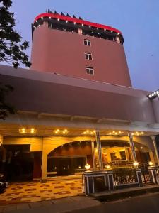 a large building with a lighthouse on top of it at Hotel Presidency in Cochin