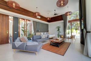 a living room with a couch and a table at The Studios Ubud in Ubud