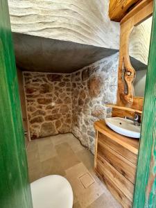 a bathroom with a sink and a stone wall at Villa Teza Hvar in Hvar