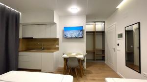 a small kitchen with a table and a sink at David's Studio Stays in Vlorë