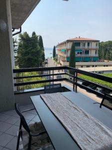 a balcony with a table and a view of a building at Residence Alexandra Stay in Sirmione