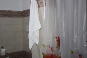 a bathroom with a shower with a white shower curtain at Casa Panoramica in Orosei