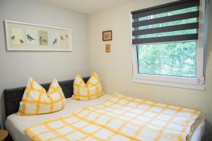 HeideseeにあるHausMeiseのベッドルーム1室(黄色と白の枕付きのベッド1台付)