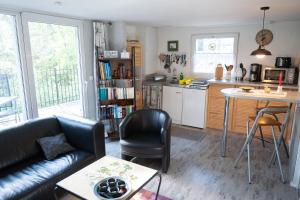 a living room with a couch and a kitchen at HausMeise in Heidesee