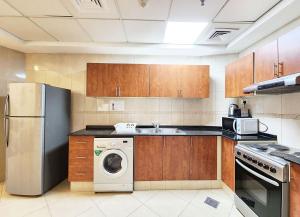 a kitchen with a washer and dryer in it at RH- Modern Urban Oasis, 02RB near mall of Emirates in Dubai