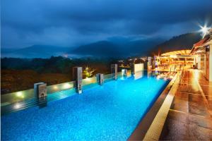 uma piscina de hotel à noite com vista em Flemington Hotel em Taiping