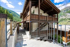 a building with a staircase on the side of it at Mountain View Apartment in Zermatt - Denali in Zermatt