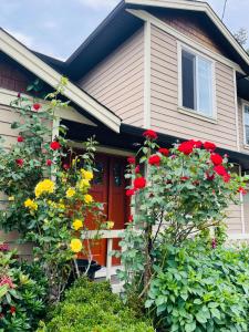 a house with a red door and some flowers at Garden home in Victoria -Beautiful home in Victoria in Victoria