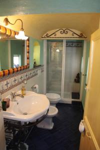 a bathroom with a sink and a toilet and a shower at Casa Nobile in Tovo San Giacomo