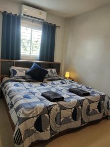 プーケットタウンにあるcross 4のベッドルーム1室(青いカーテン付きの大型ベッド1台付)