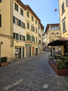 an empty street in an old town with buildings at Charming house in San Niccolò in Florence