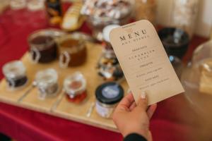 a person holding a menu in front of a table at Hotel Rinno in Vilnius