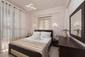 a bedroom with a bed and a desk and a window at Villa Debora in Zakynthos Town