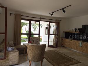 a living room with a couch and a chair at Sonrisa Villas in Diani Beach