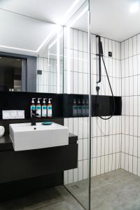 a bathroom with a sink and a shower at Stey Wangfujing Hotel in Beijing