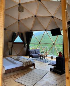 a room with a bed in a large tent at North Dome & Suite in Rize