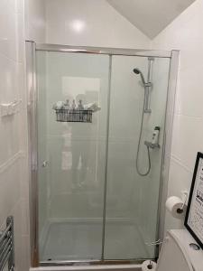 a glass shower in a bathroom with a toilet at Cozy Retreat in Luton in Luton