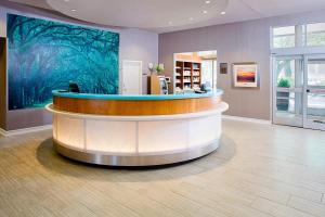 a lobby with a circular counter and a large painting at Springhill Suites by Marriott Savannah Downtown Historic District in Savannah