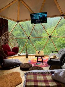 a living room with a view of a tent at North Dome & Suite in Rize